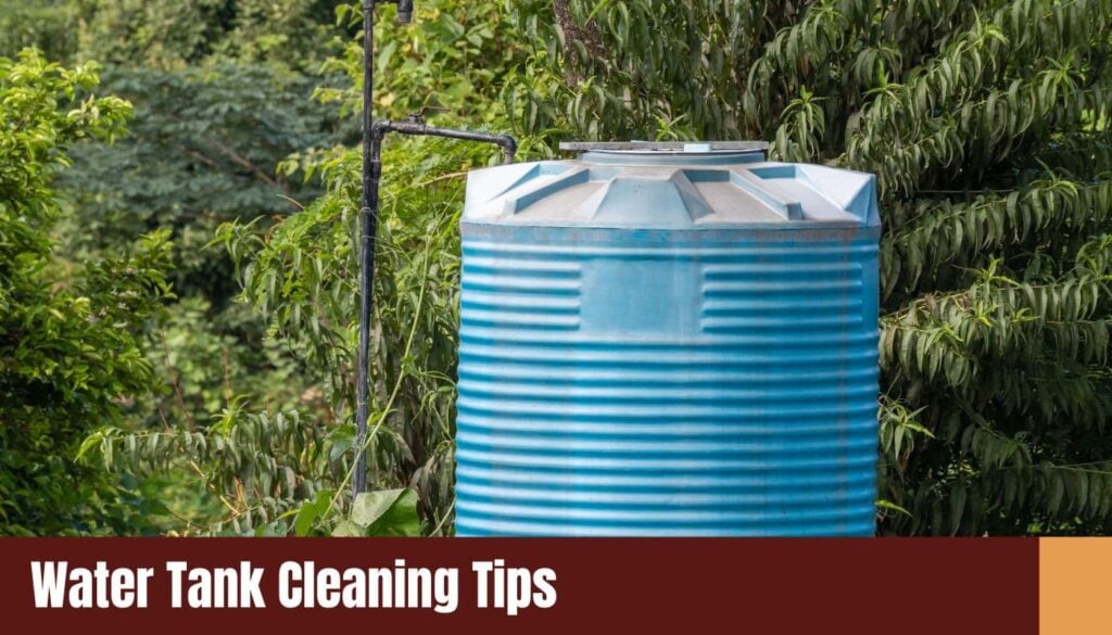 A large, ribbed blue polyethylene water storage tank positioned outdoors amidst lush green trees and foliage.
