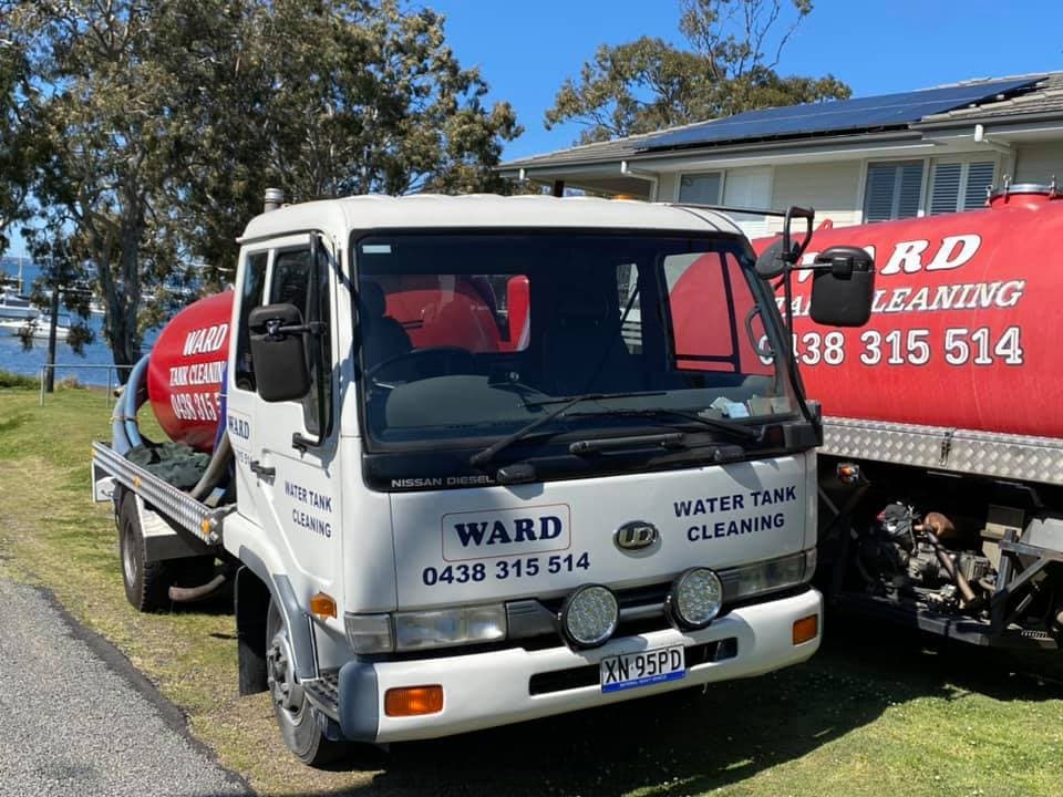 A white Nissan Diesel service truck labelled "WARD WATER TANK CLEANING"