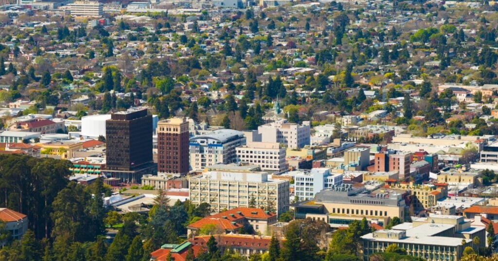An elevated, wide-angle aerial view of a sprawling city centre featuring a mix of mid-rise commercial buildings.