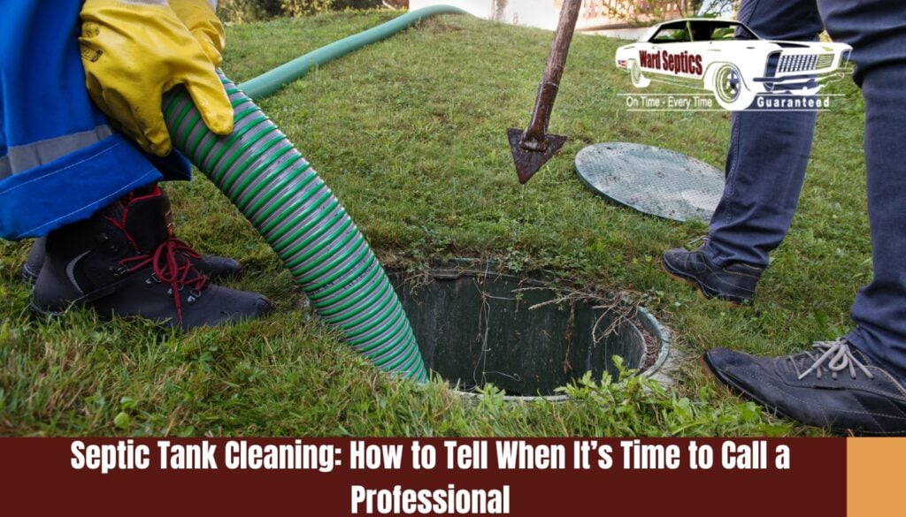 A worker with bright yellow gloves inserting a thick green ribbed suction hose into an open ground-level septic tank on a grassy lawn.