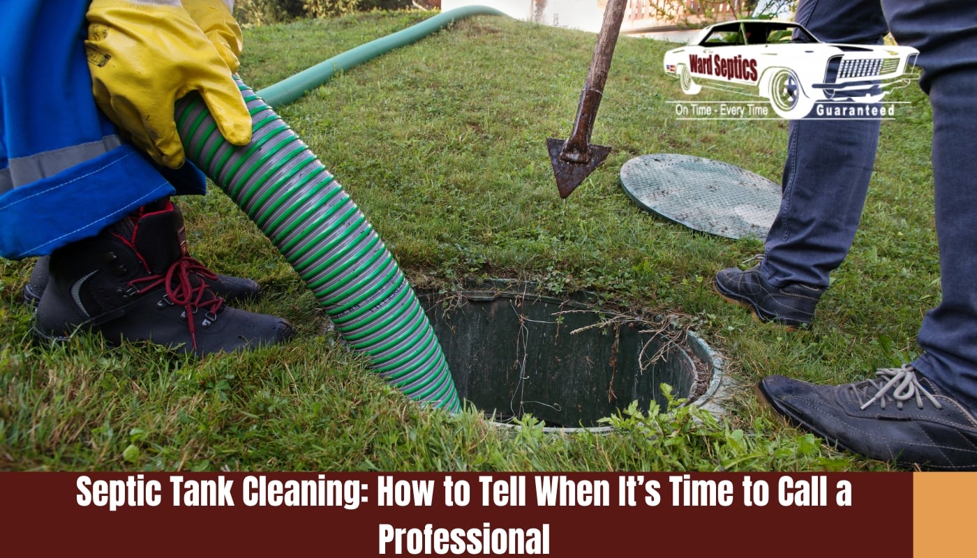 A worker with bright yellow gloves inserting a thick green ribbed suction hose into an open ground-level septic tank on a grassy lawn.