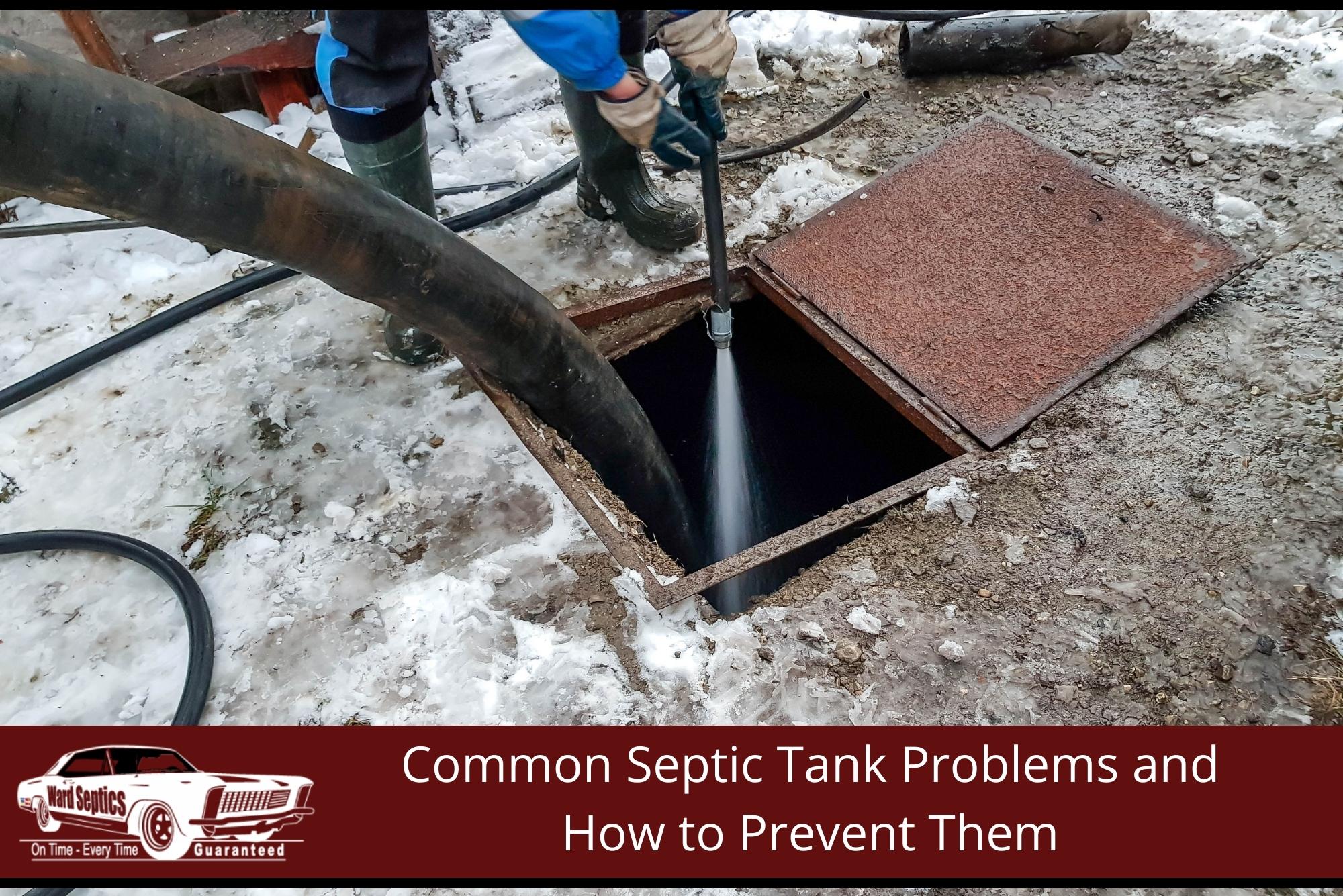 A worker spraying a high-pressure water stream down into an open septic tank hatch while a large vacuum hose pumps out waste on a snowy ground.