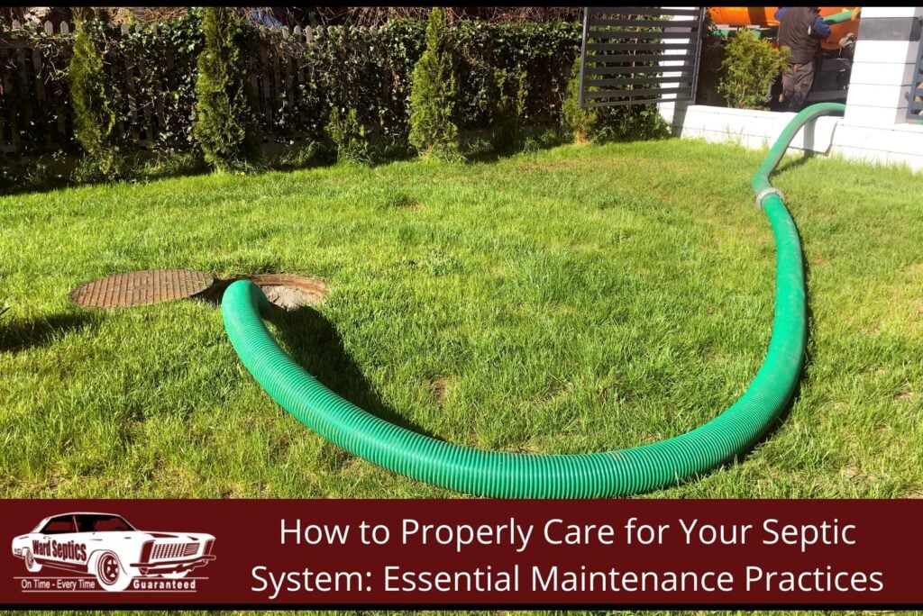 A large green hose running across a grassy lawn from an open septic tank manhole to a service truck.