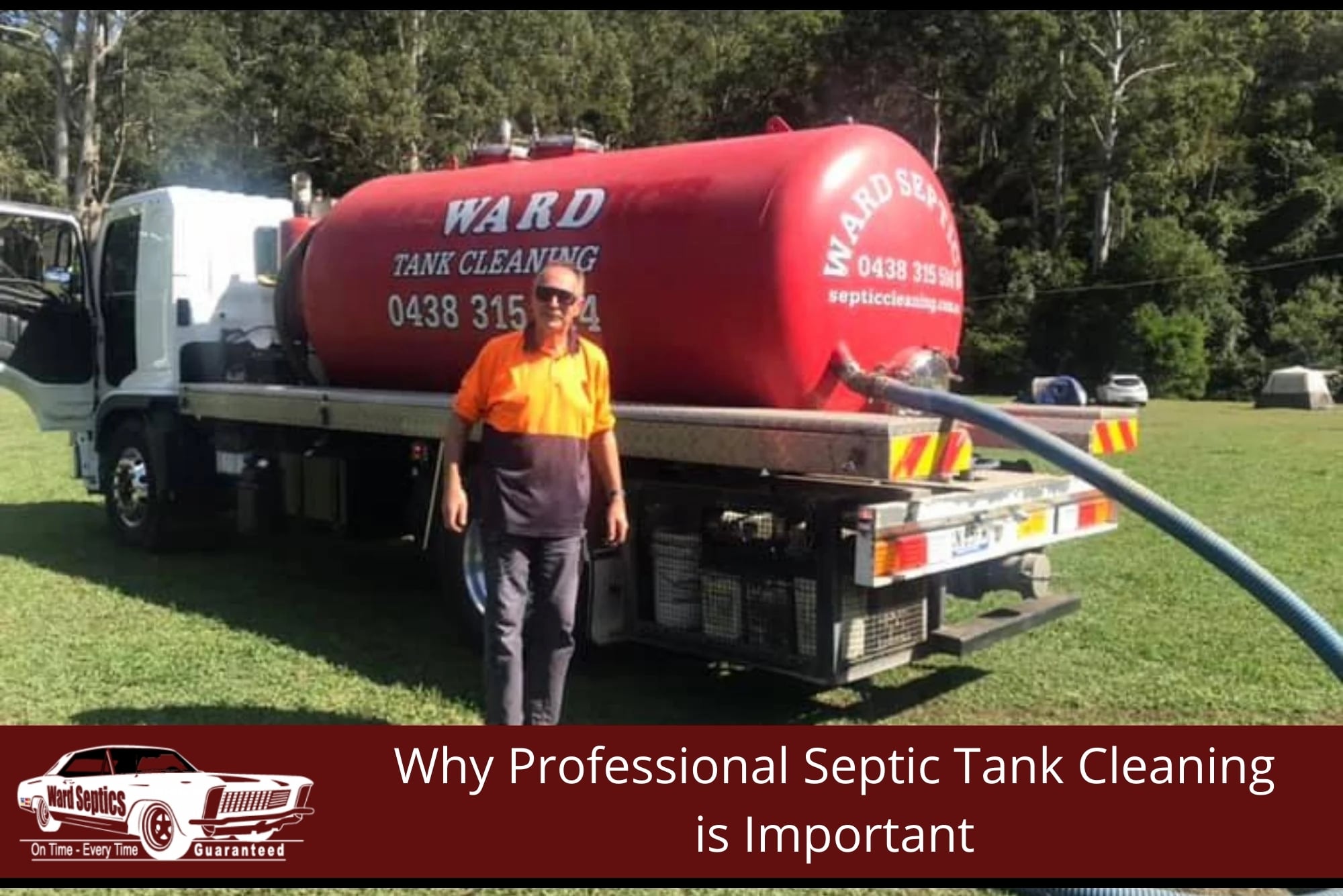 A technician in high-visibility clothing stands beside a white flatbed truck carrying a large red septic tank cleaning pump.