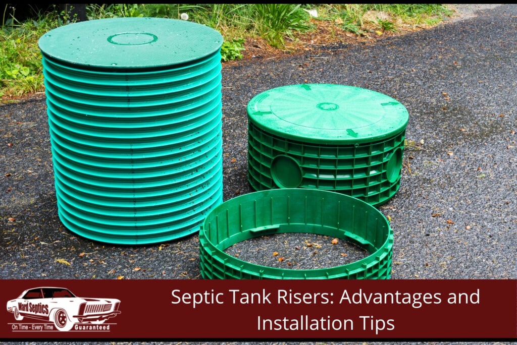 Green plastic septic tank risers and covers sitting on an asphalt driveway.