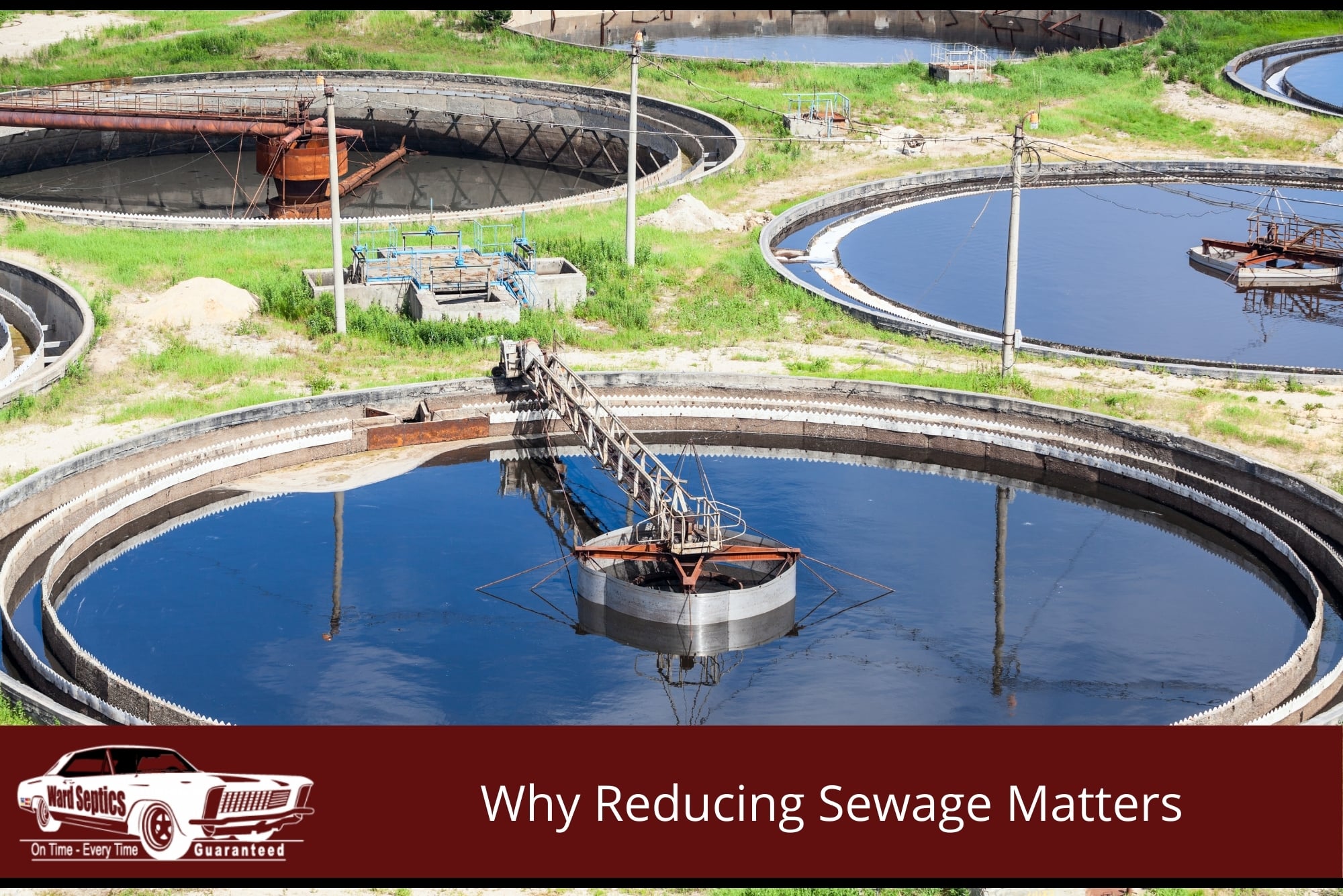 An elevated view of several large, circular primary clarifier tanks filled with dark water at a wastewater treatment facility.