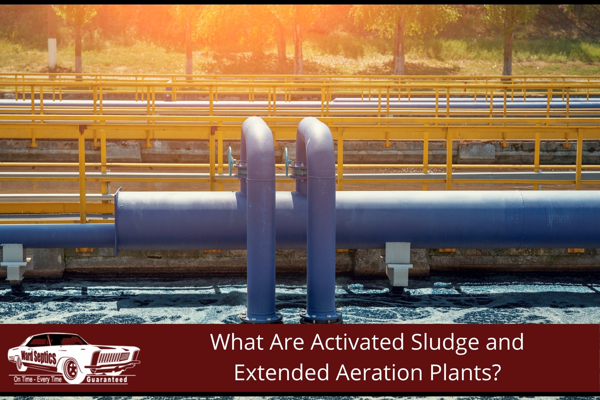 A large blue industrial pipes and valved loops carrying airflow or wastewater over a bubbling aeration basin at a treatment plant.