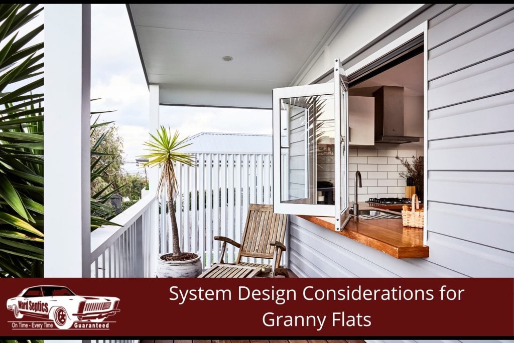 A modern granny flat balcony looking through a wide, open window onto a kitchen countertop.